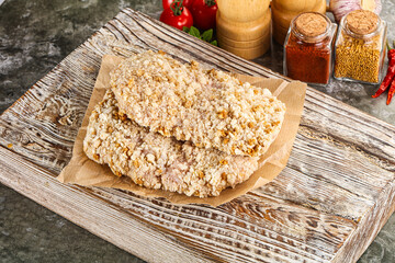 Breaded raw breaded meat schnitzel