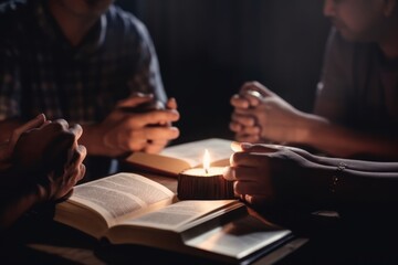 Close up of young people reading holy bible in dark room at night