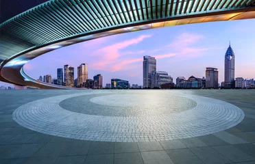 Fotobehang Round square floor and pedestrian bridge with modern city buildings at dusk in Shanghai © ABCDstock