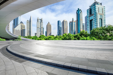 Round square floor and pedestrian bridge with modern city buildings scenery in Shanghai. Famous...