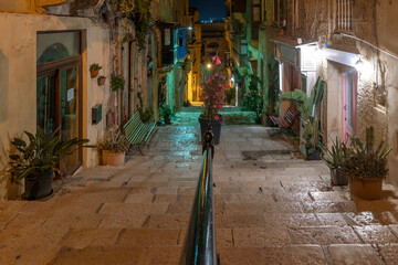 Triq it-Teatru L-Antik, a typical alley in the historic center of Valletta, Malta, in the twilight light