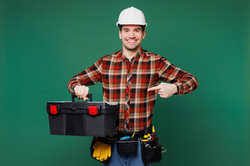 Young employee laborer handyman man wear red shirt hardhat hat work hold point on toolbox isolated...