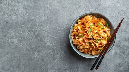 Garlic Chili Oil Noodleson a concrete background, chinese cuisine, top view, copy space