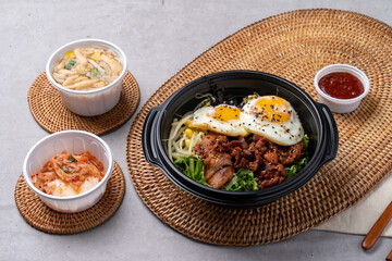 Korean food, bulgogi, bibimbap, beef, vegetables, eggs, side dishes, kimchi, fried tofu, red pepper paste