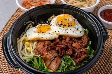 Korean food, bulgogi, bibimbap, beef, vegetables, eggs, side dishes, kimchi, fried tofu, red pepper paste