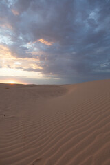Sunset over the sand dunes in Sahara desert near Tozeur - 754850503