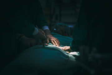 Surgeon team working with patient in surgical operating emergency room in hospital