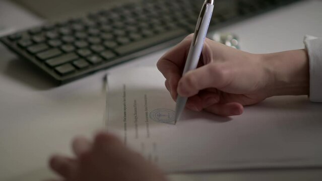 Doctor puts seal on closeup of medical documents