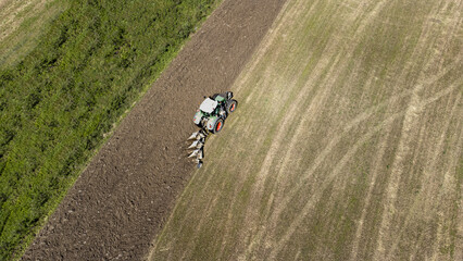 Aerial view of a tractor preparing the field for planting. - 754868180