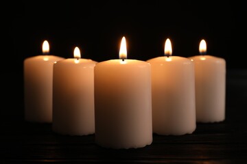 Burning candles on dark background. Memory day