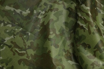 Texture of crumpled camouflage fabric as background, top view