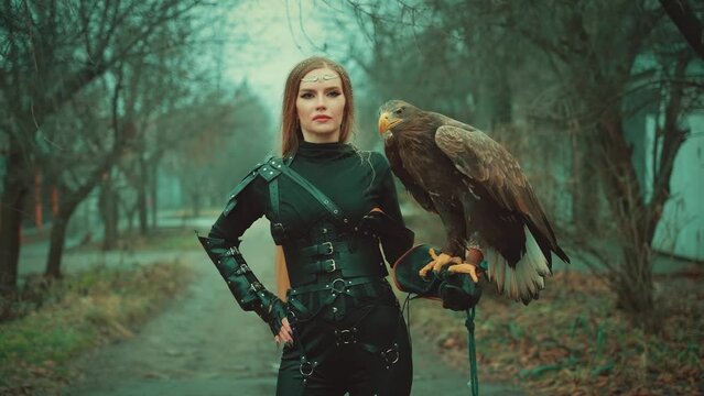 art fantasy woman warrior holding white-tailed eagle wild bird on hand animal pet flaps brown big wings, girl blond hair Sexy face fashion model. Lady queen hunter black dress armor. dark trees fog 4k
