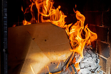 burning pizza boxes indoors on a dark background. . Ecological catastrophy