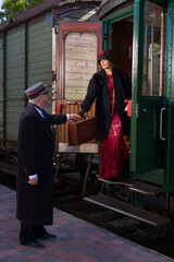 Conductor helping Flapper dress lady