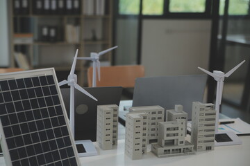 Close-up at tablet, Engineers pointing at tablet with their hands. To jointly design the use of renewable energy with wind and solar energy. Concept of using renewable energy.