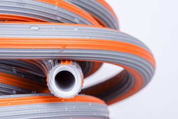 Rubber water hose coiled up, close-up - 754890741