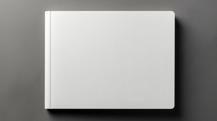 Fototapeta premium Top view of a blank white magazine on a gray background, serving as a design template mockup.
