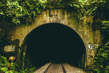 Railway tunnel in the forest of India, vintage filter effect, retro style.
