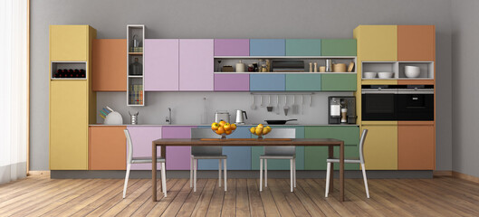 Modern kitchen interior with colorful cabinets and dining table