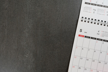 close up of calendar on the black table background, planning for business meeting or travel planning concept