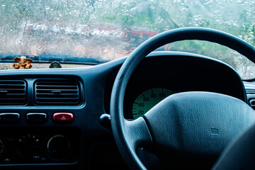 Interior of a car, steering wheel and dashboard View from the driver's seat.