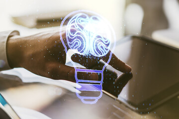 Double exposure of creative light bulb hologram with human brain and with finger clicks on a digital tablet on background, idea and brainstorming concept