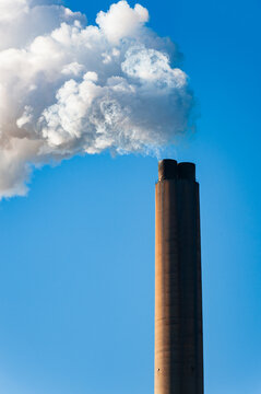 Closeup of the top of a smokestack releasing steam at a power plant in Rome, Georgia