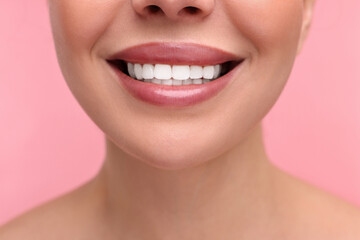 Obraz premium Woman with beautiful lips smiling on pink background, closeup
