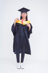 Full body photo of a happy female graduate of bachelor of science holding her diploma. Beaming with...