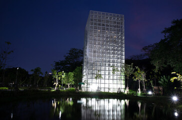 White steel frame tower with reflection at Pupha Mahanatee Garden in Queen Sirikit Park in the centre of Bangkok, Thailand.