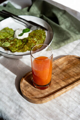 Carrot juice in a glasses on breakfast table