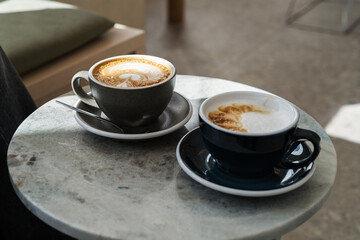 Close up of Cups with morning coffee on marble table