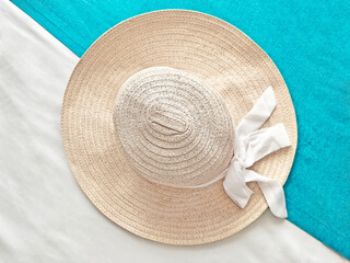Overhead View Of Summer Hat With Ribbon Bow On Blue And White Textile Textured Background