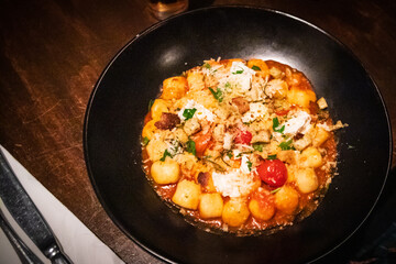 Gourmet Gnocchi Dish Garnished with Fresh Herbs and Cheese
