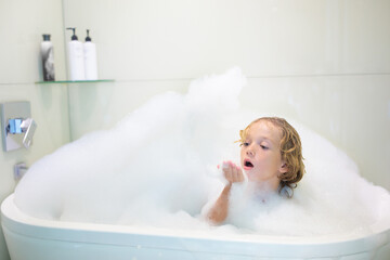 Child playing with foam in bath