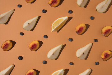 Creative minimal layout made from sliced pear, peach and blueberry  on pastel background. Flat lay. Pattern concept.