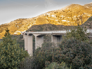 Nervi torrent viaduct on the A14 Azzurra highway near Genoa, Italy. In the background is Mount Moro