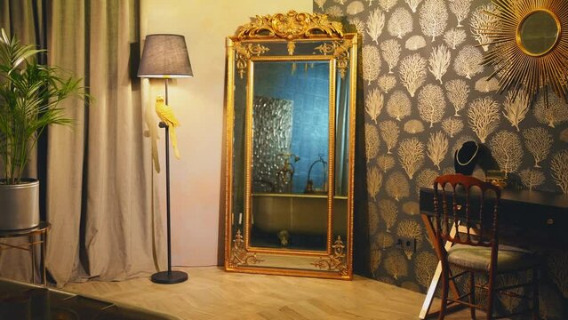 magical old vintage style mirror with blue glow magic light stands in classic luxury cozy room, golden frame luxury interior gold color