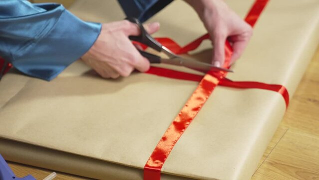 Trying on red ribbon and gluing it to craft