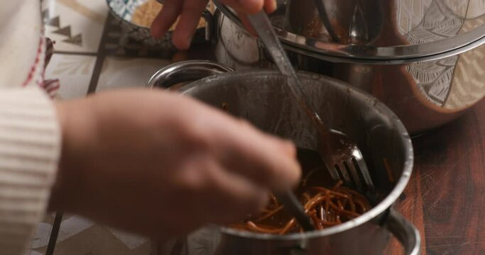 Amidst the aroma of spices, the Arab woman gently submerges chebakia into luscious honey, adding a layer of sweetness to the cherished Moroccan delicacy