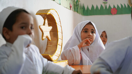 Kindergarten children wearing prayer clothes to celebrate of Ramadan. Ramadan Crescent.