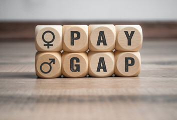 Cubes, dice or blocks with gender pay gap on wooden background
