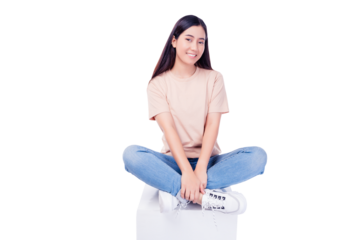 Full body Happy smiling young asian lady sitting crossed legs on wooden tube box looking to camera blank space isolated on white background