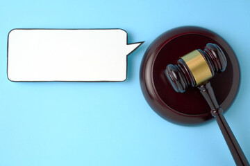 Judge gavel and speech bubble on a blue background