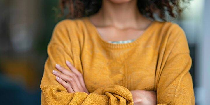 Close-up of a person with crossed arms, body language indicating defensiveness or resistance to opening up in a difficult conversation , concept of Nonverbal communication
