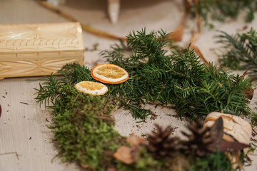 Process of making Advent wreath, natural materials only, such as moss and dried orange slices 