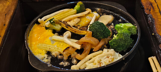 Food in a black iron skillet. Cooking with a skillet