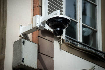 closeup of security camera on building facade in the street - 754998984