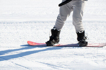 A snowboarder rides a snowboard. Winter recreation.Snowboarding on the mountain.