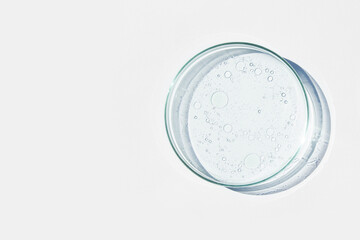 Petri dish. Petri's cup with liquid. Chemical elements, oil, cosmetics. Gel, water, molecules,...